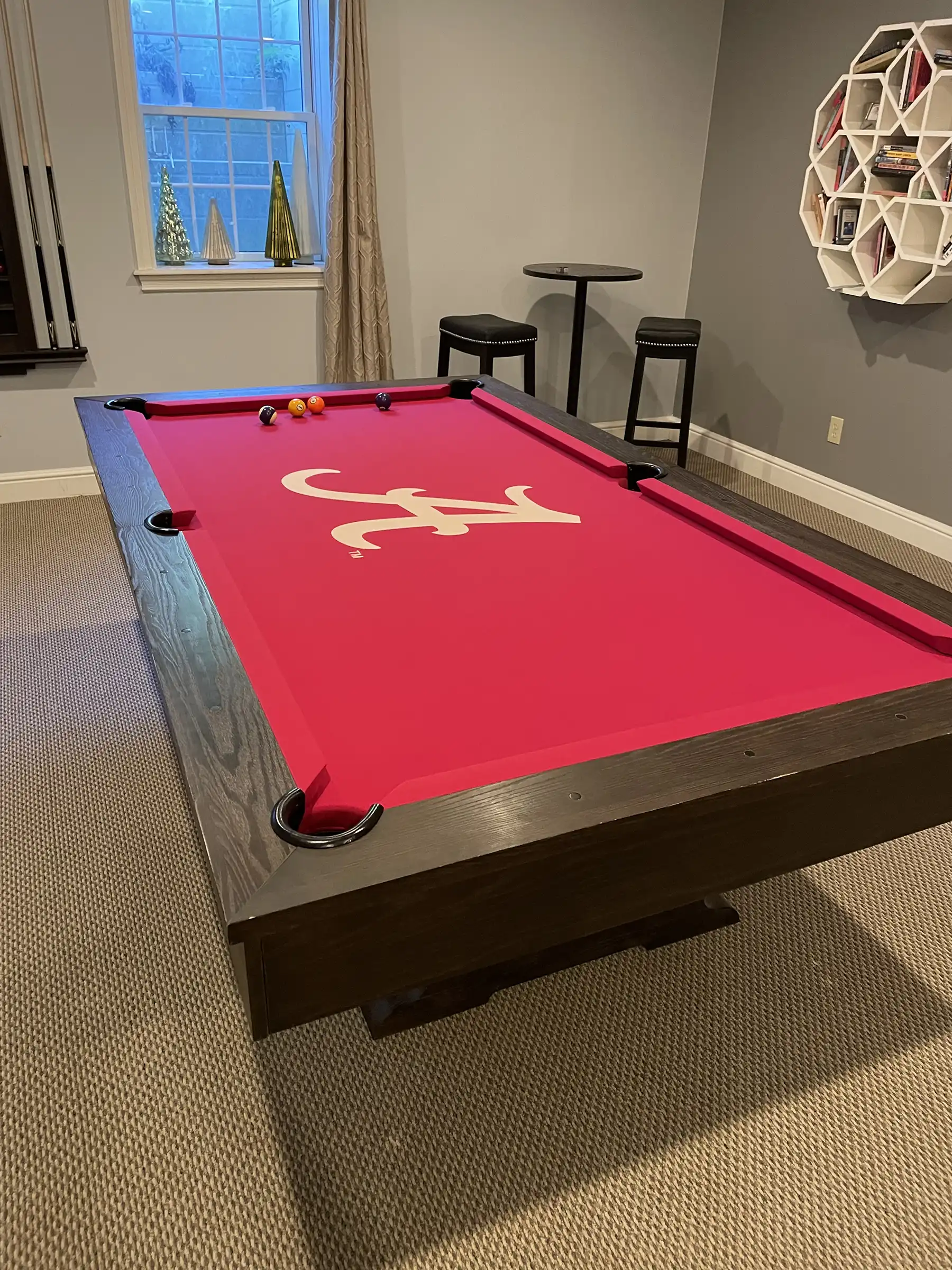 Red pool table with Alabama Crimson logo