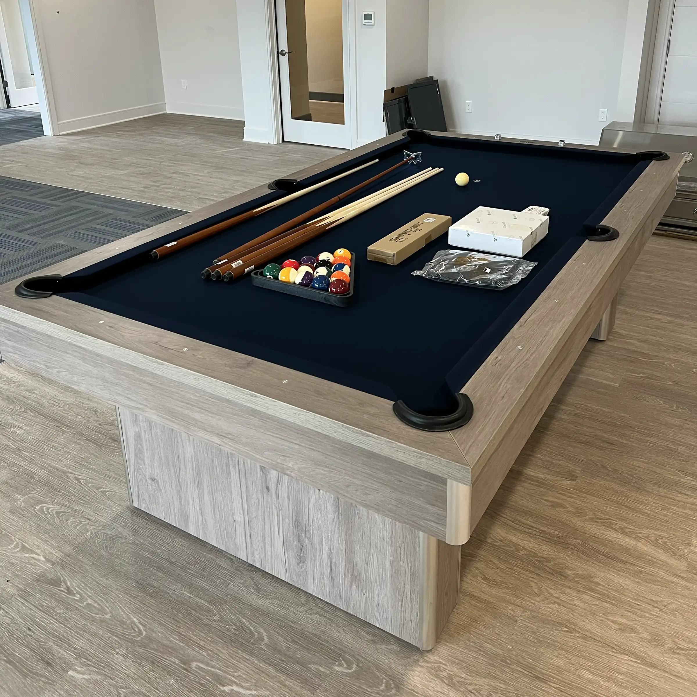 black felt pool table with wood frame