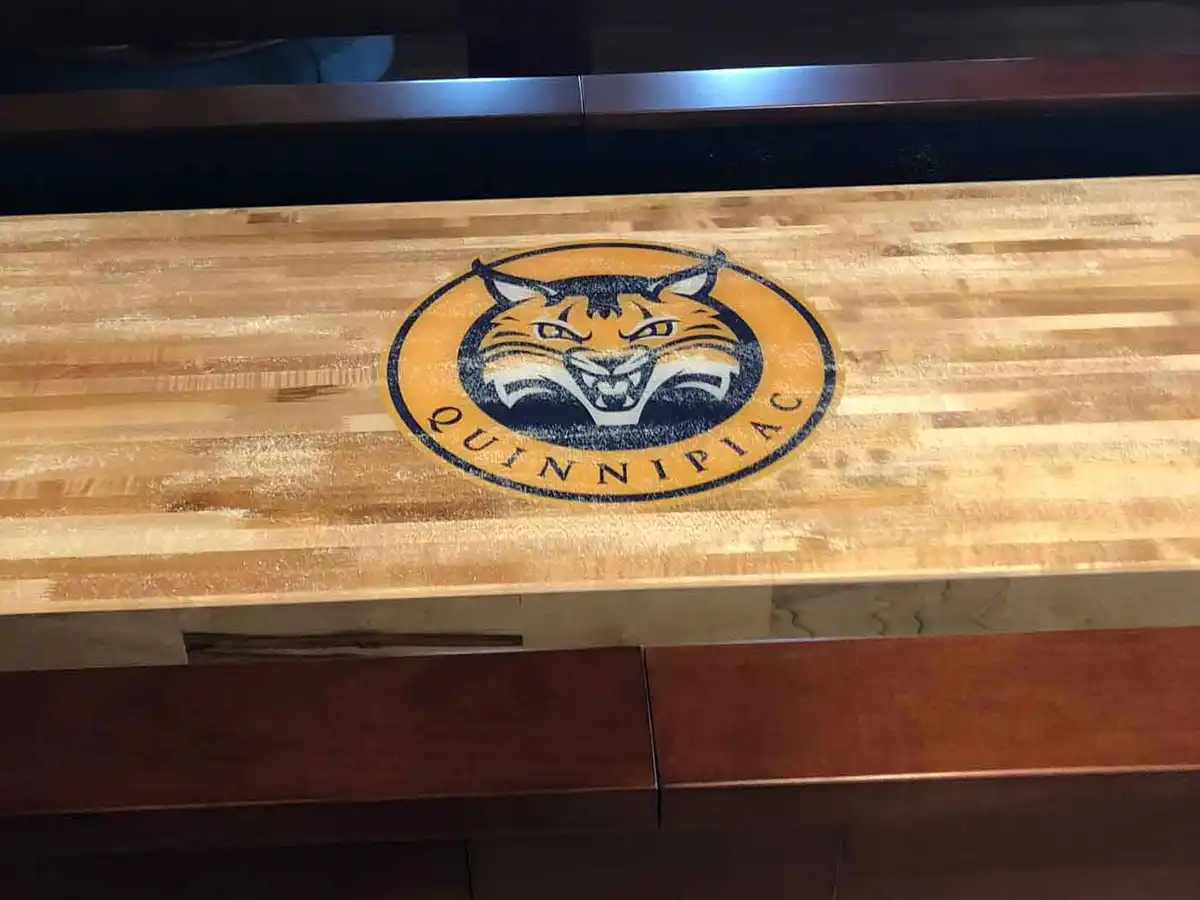 Quinnipiac University logo on a shuffleboard table