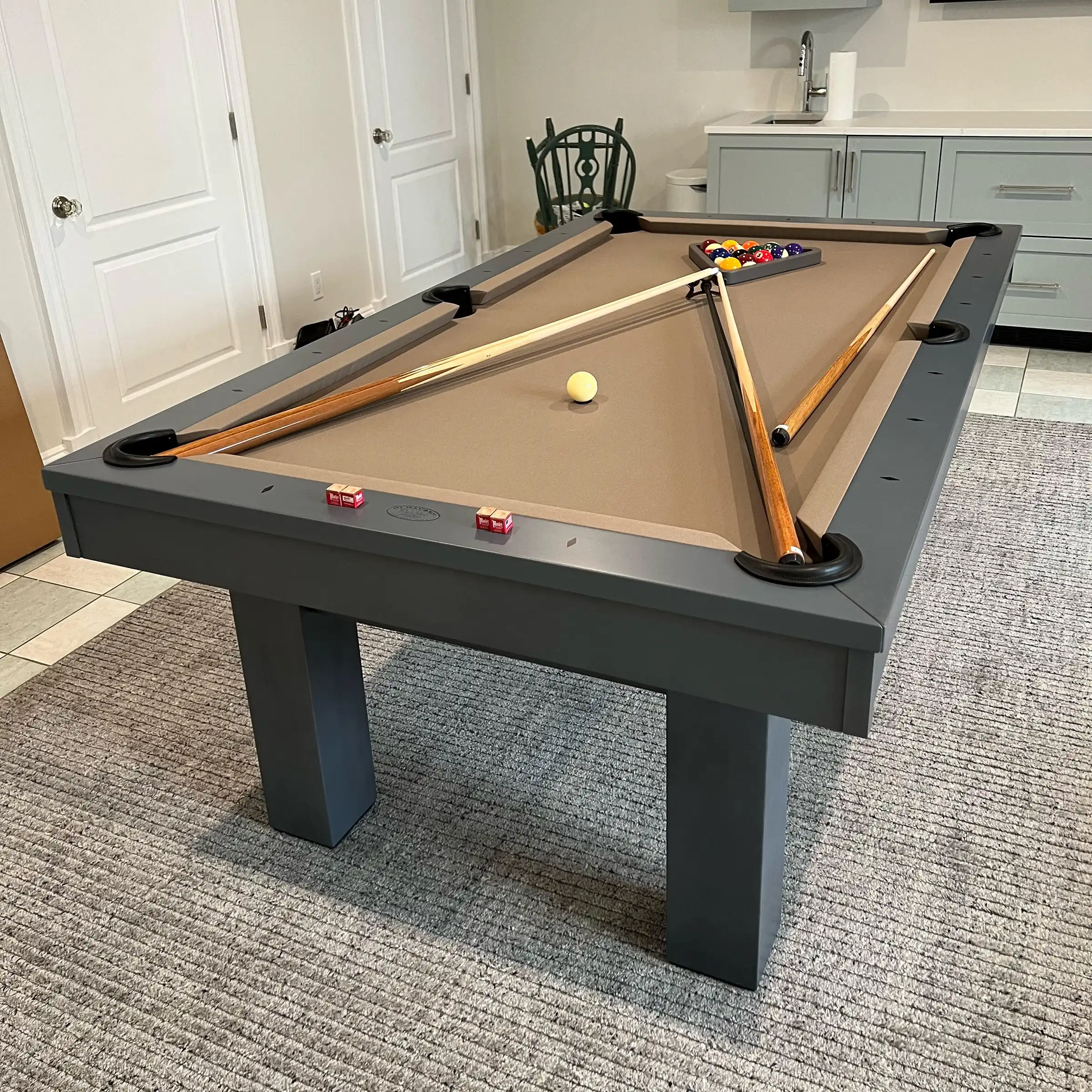olhausen pool table with tan brown cloth on a grey rug