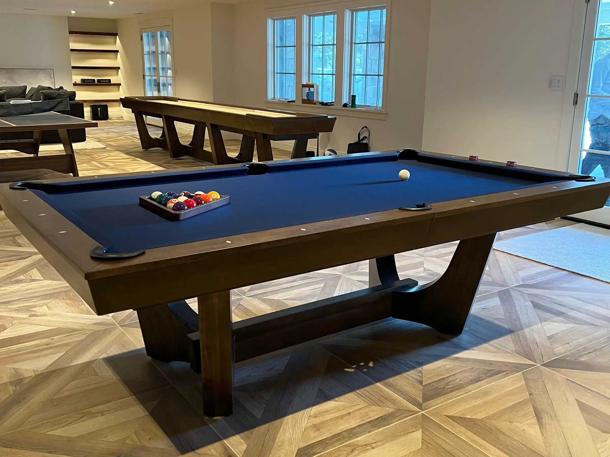 blue pool table, shuffleboard, and ping pong table tennis game room