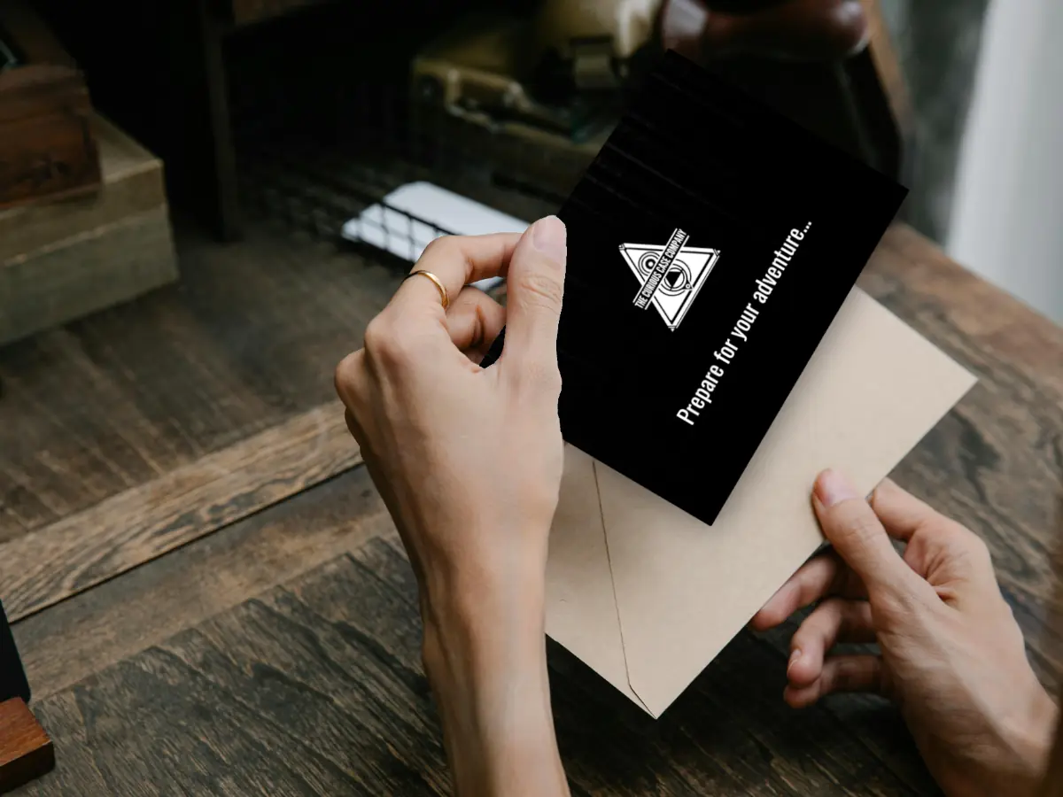 Hands removing a personalised Curious Case gift card from its envelope