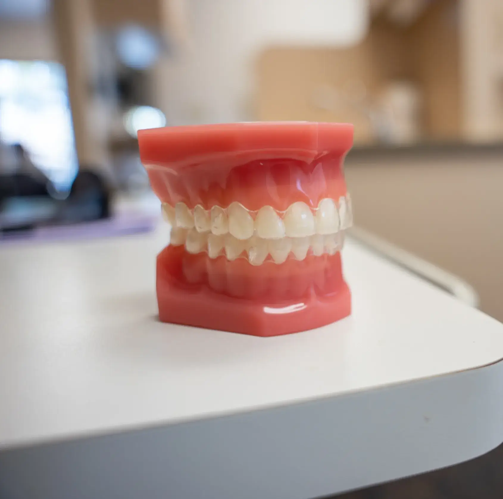 A dental model showing a set of teeth on a table in a dental office.