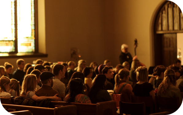 Sepia toned congregation inside a chapel