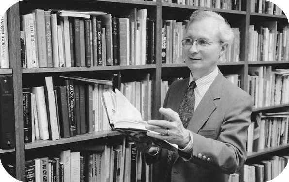 Historic photograph of a theologian reading in a library