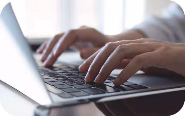 Someone typing on a computer