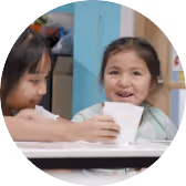 Two young children sitting together at a table