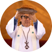 Clergy member holding a book during a worship service