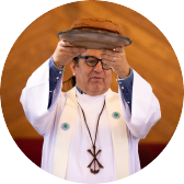 Clergy member holding a book during a worship service