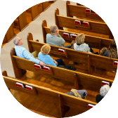 People seated in church pews during a service