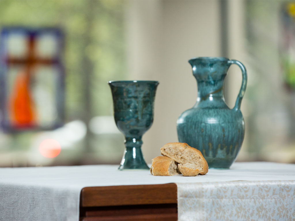 Communion bread and chalice prepared on a church altar