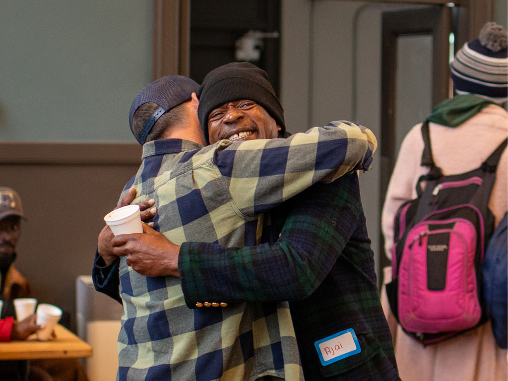 Two people hugging outdoors