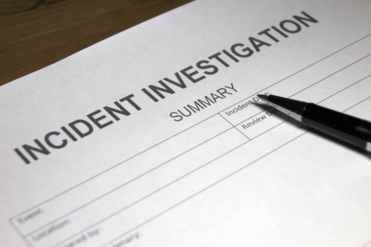Incident investigation document with a pen on top