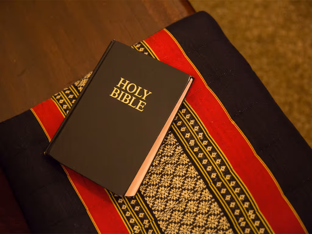 Closed Bible resting on a patterned cloth