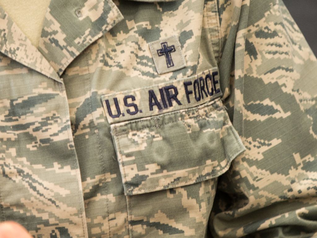 Close-up of a US Air Force camouflage unform with a small cross above the pocket.