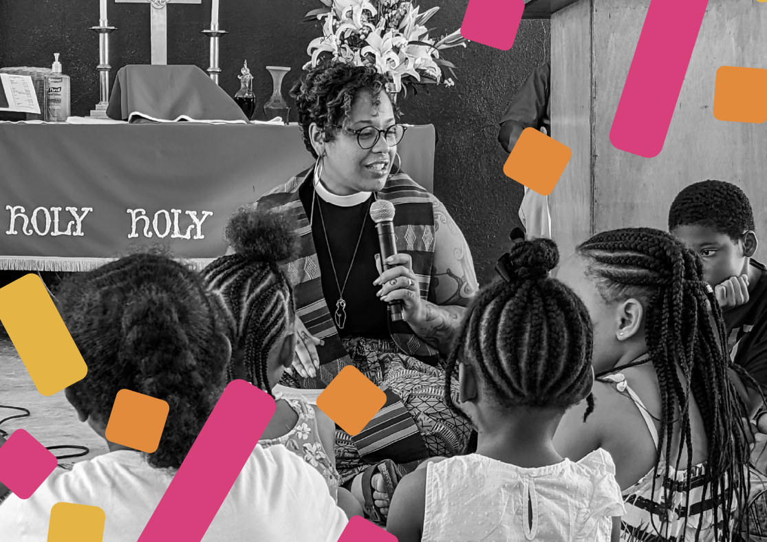 b&w picture of a woman giving a children’s sermon with orange, pink and yellow confetti 