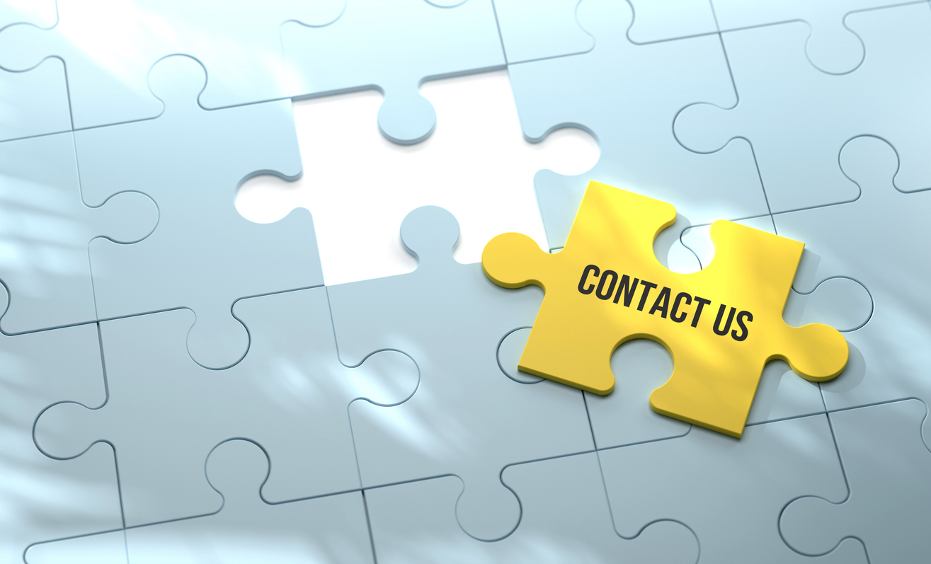 Blue puzzle with an empty space and a yellow piece with the words “contact us” sitting on top. 