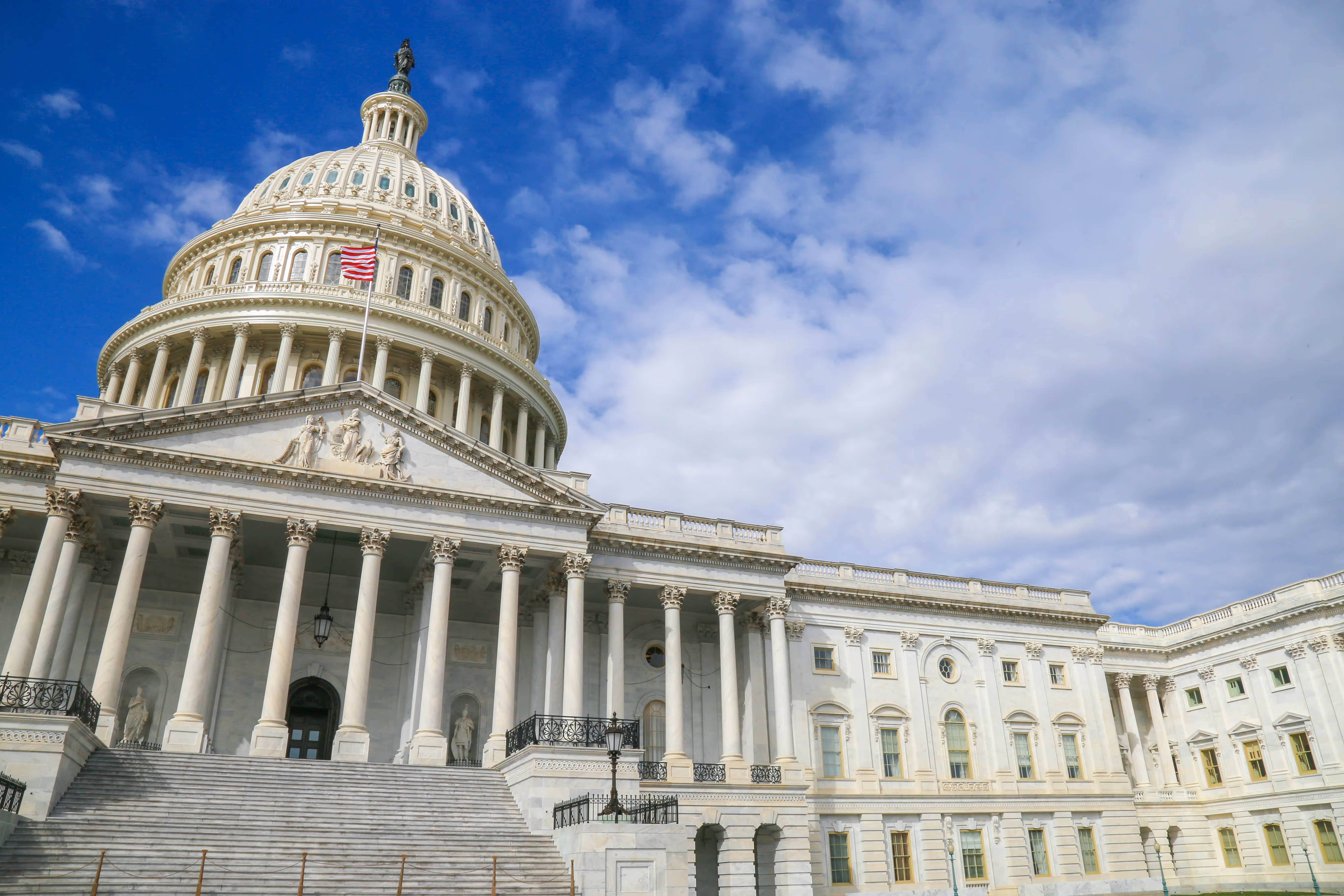 head-on view of the United States Capitol building from the base of the steps by Louis Velazques for Unsplash. 