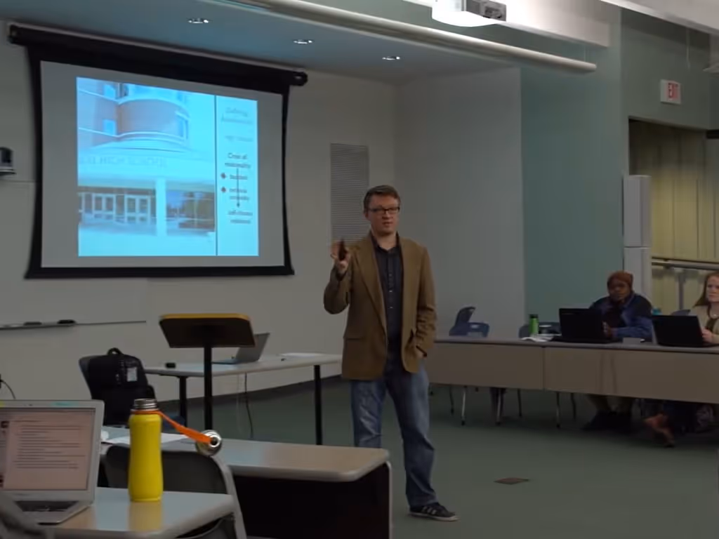 Person giving a presentation in front of a projected screen