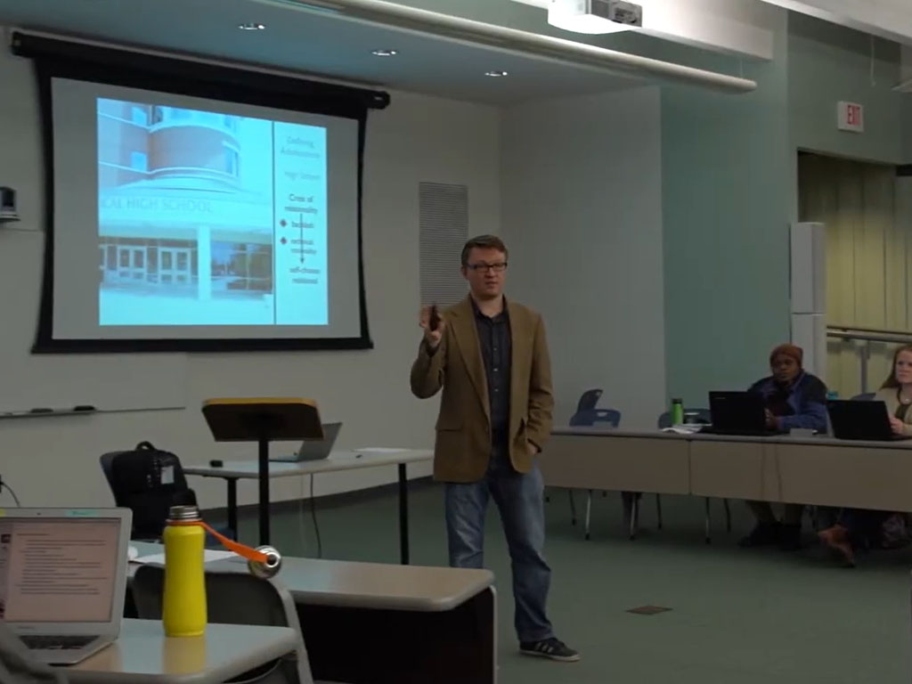 Person giving a presentation in front of a projected screen