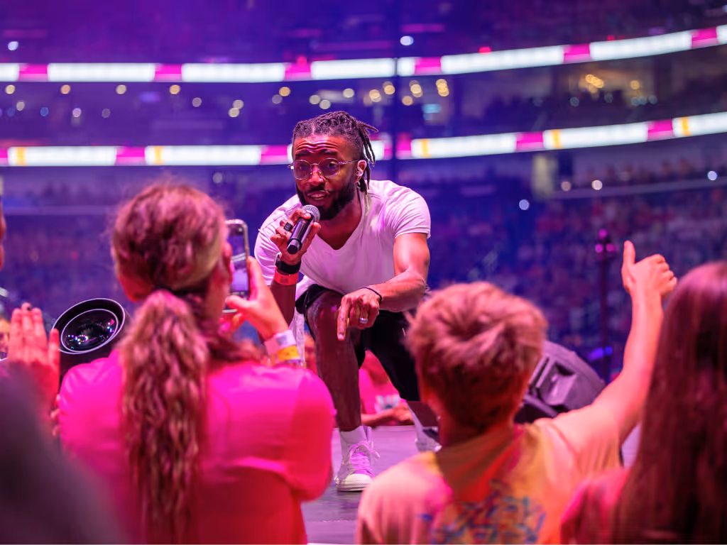 Performer on stage with young people gathered in front