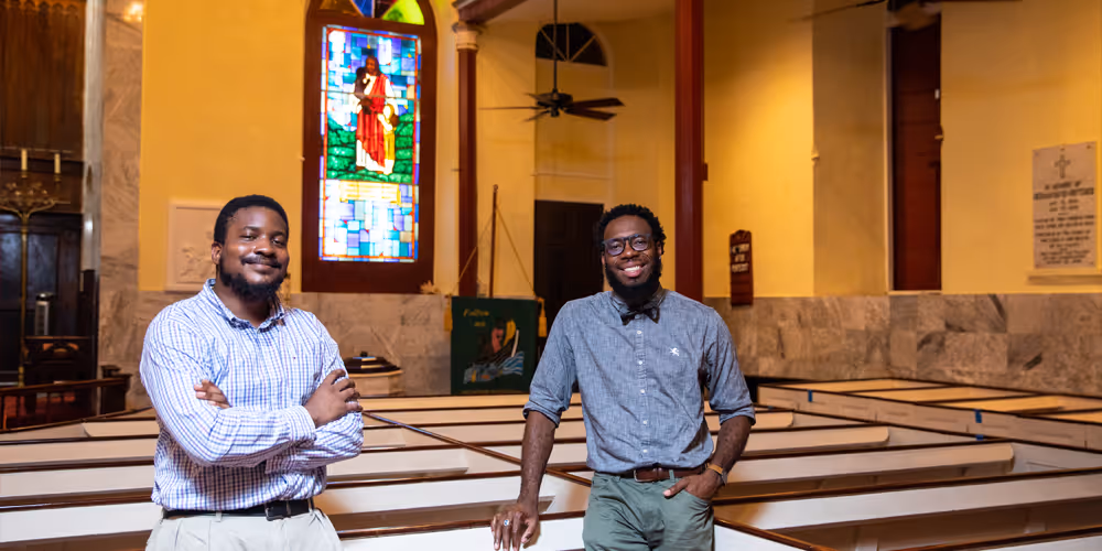 Female pastor sits with a group of children in front of an altar with green paraments in a church in St. Croix. 