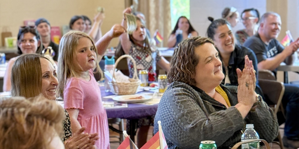 Several people attend a bingo event in a church