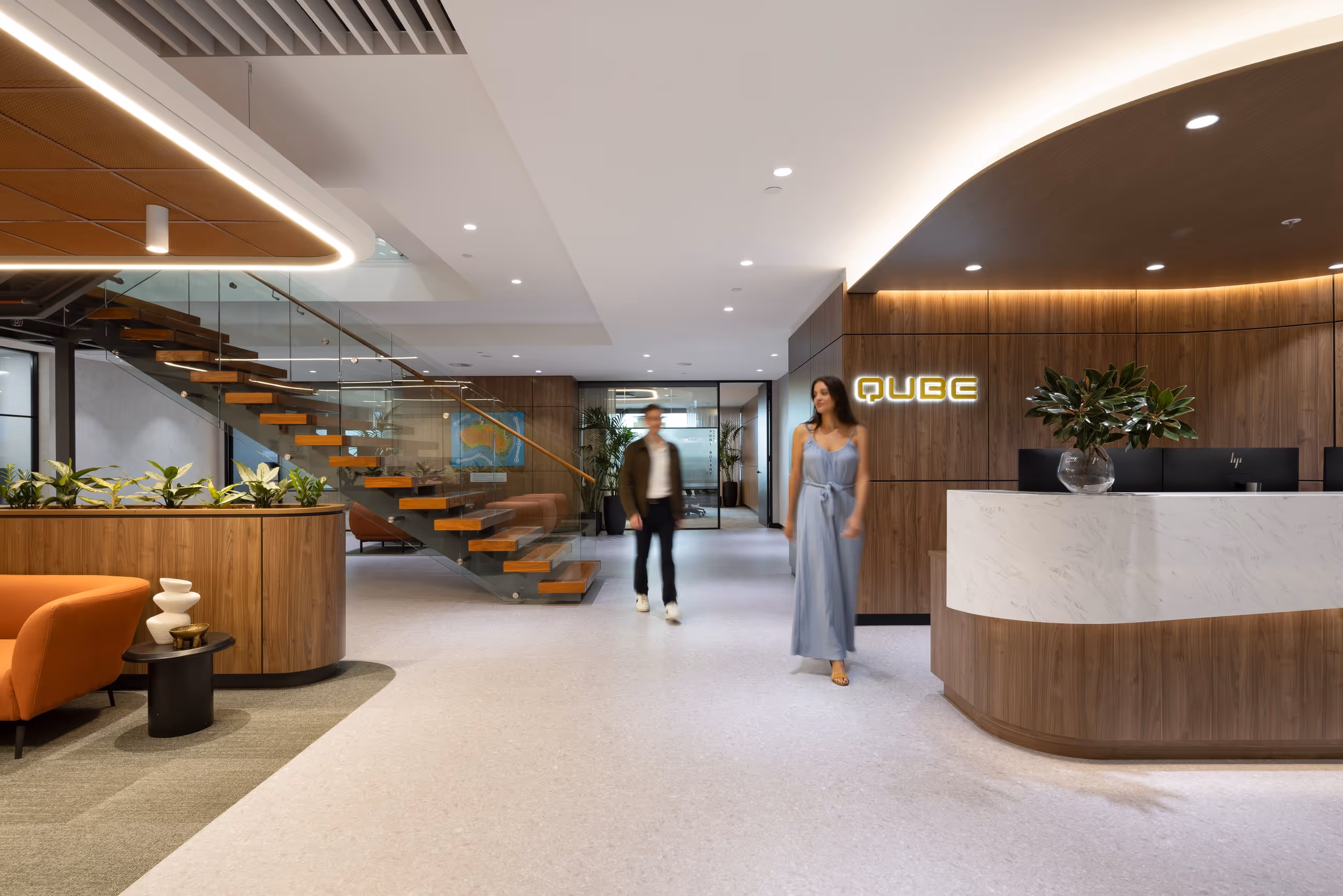 two people walking surrounding by joinery created by Nouva for Contour Interiors