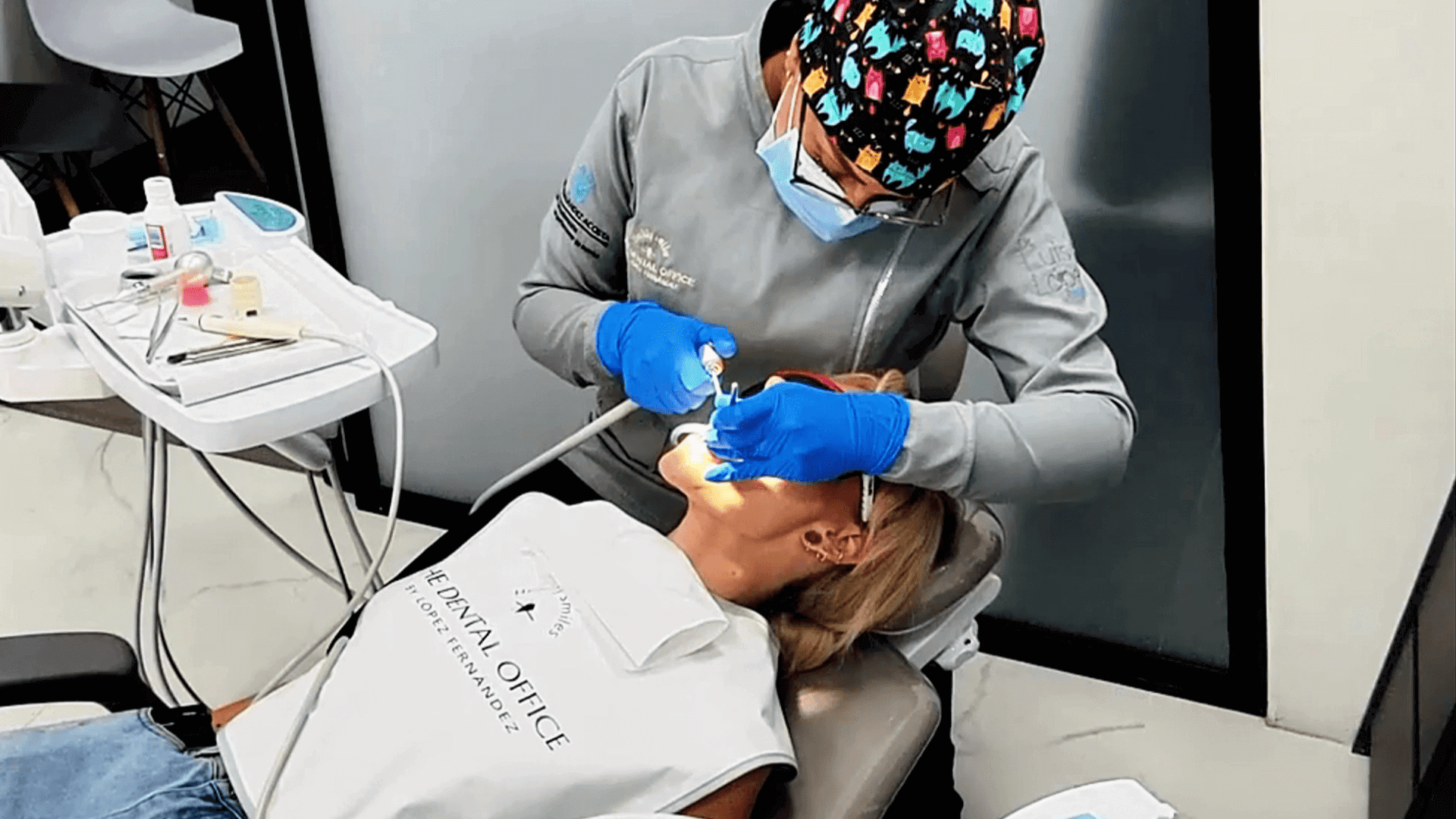 Dentist in Medellín performing dental treatment on a woman patient during a dental tourism appointment in Colombia.