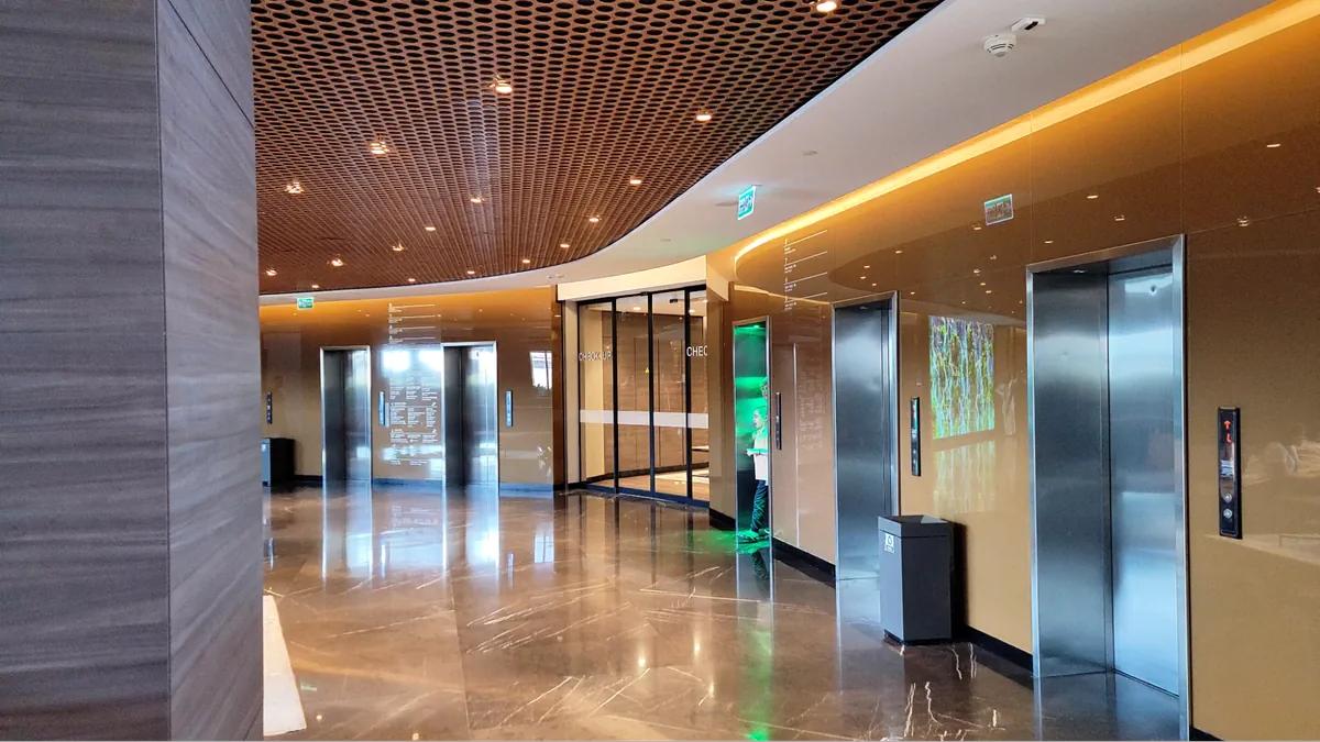 Hospital lobby with elevators and reflective marble flooring