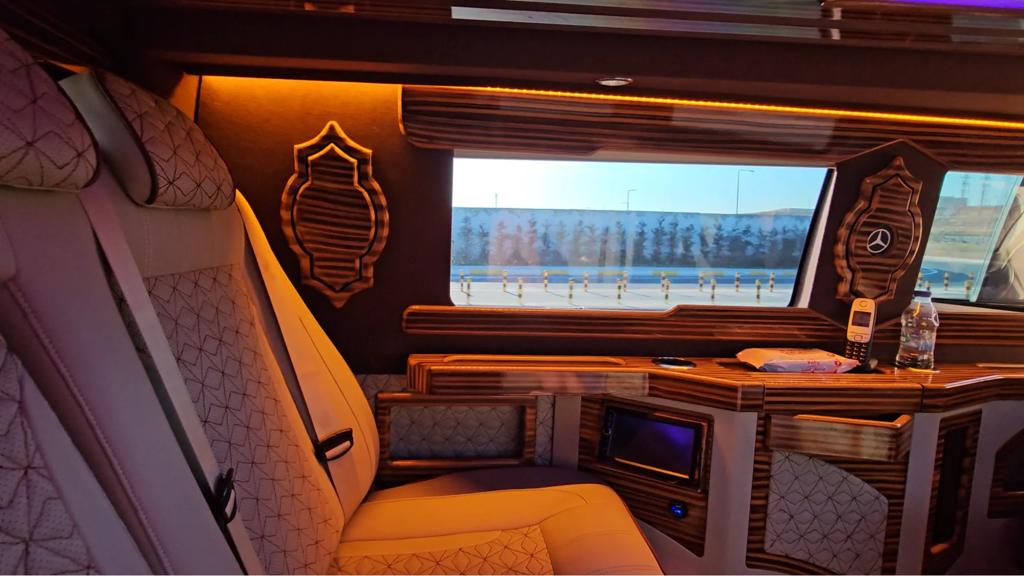 Interior of a luxury private transfer van in Istanbul with leather seating and wood paneling