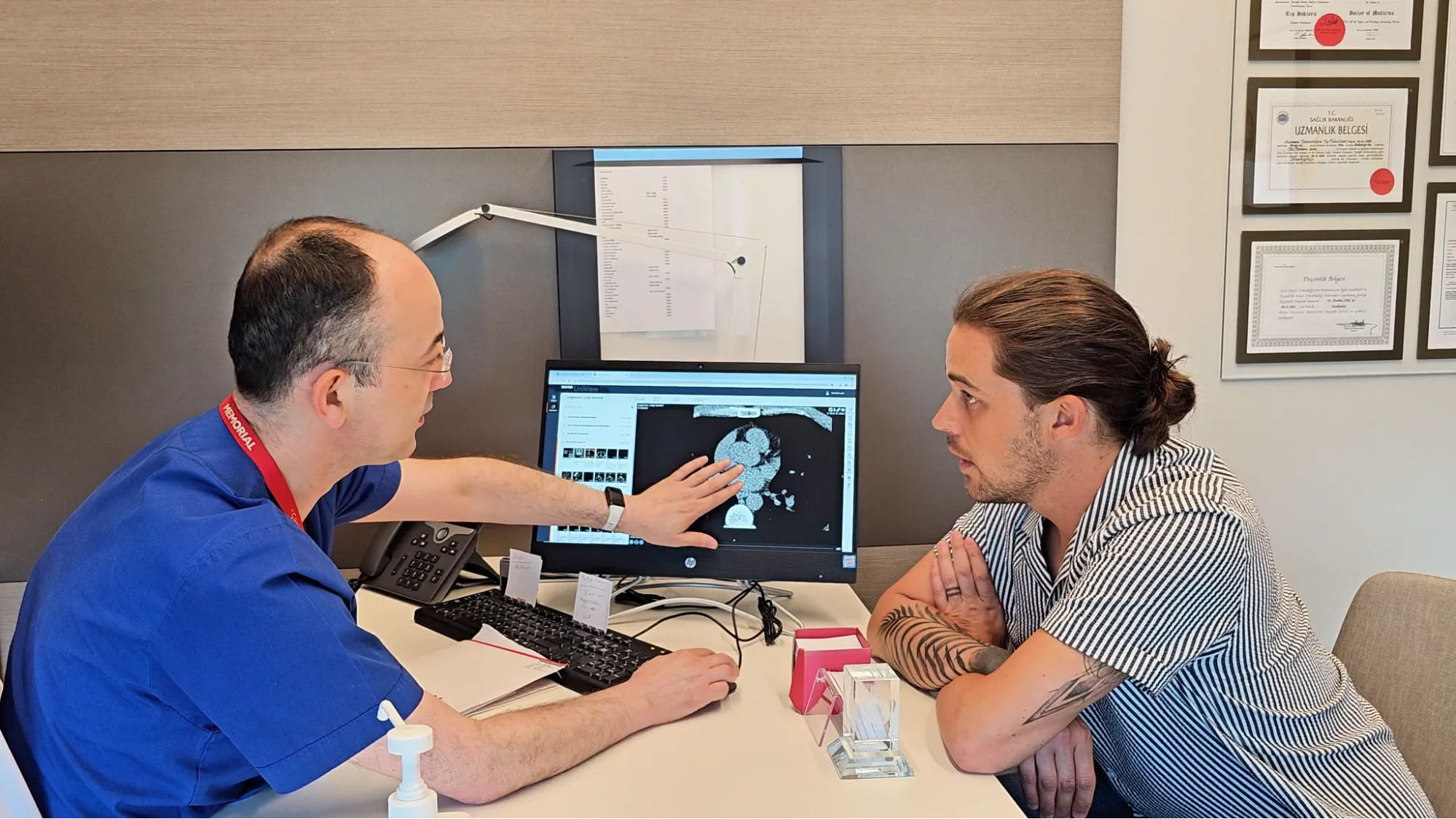 A Turkish doctor reviews CT scan results with a patient during a full-body checkup at Memorial Hospital.
