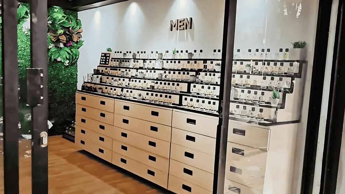 Display shelves filled with perfume bottles at Cocora perfume shop in Medellín, Colombia