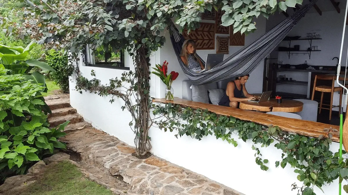 working remotely in a hammock and at a table in a tropical coworking retreat in Colombia