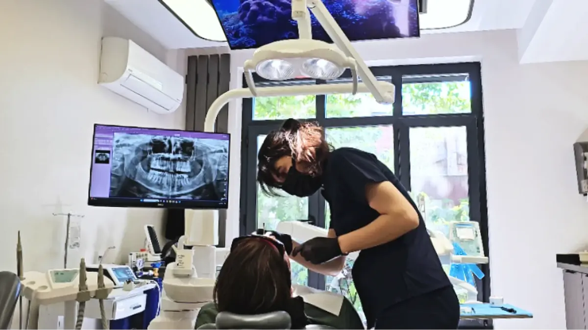 Dentist examining a patient with a digital X-ray display in an Istanbul clinic