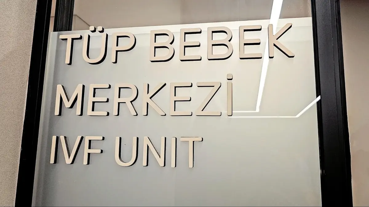 A sign reading "Tüp Bebek Merkezi IVF Unit" at Memorial Hospital in Türkiye, indicating the in-vitro fertilization department.