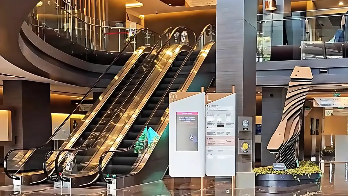 The luxurious main lobby of Memorial Hospital in Istanbul, featuring escalators, modern design, and an information directory.