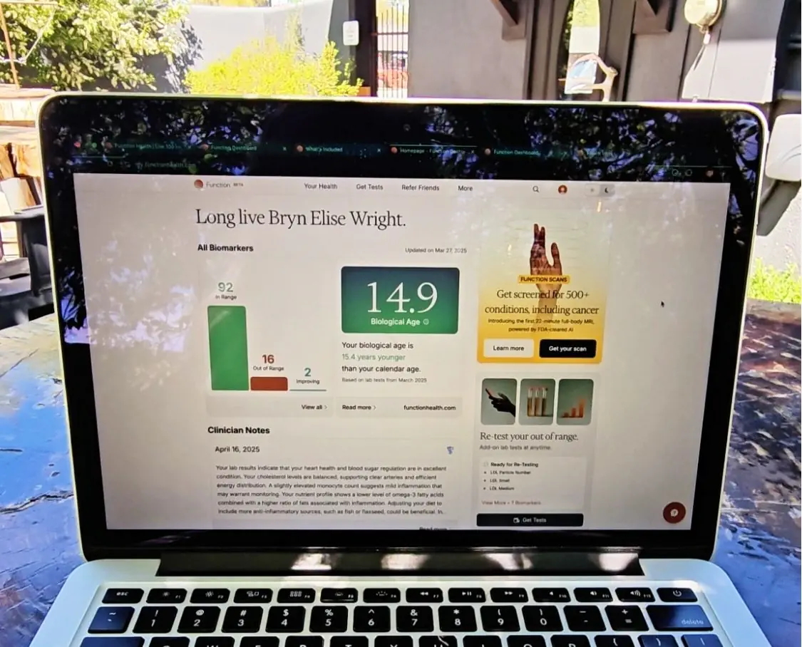 Laptop screen displaying Function Health dashboard with biomarker results and biological age score, showing affordable preventive health scan insights in the U.S.