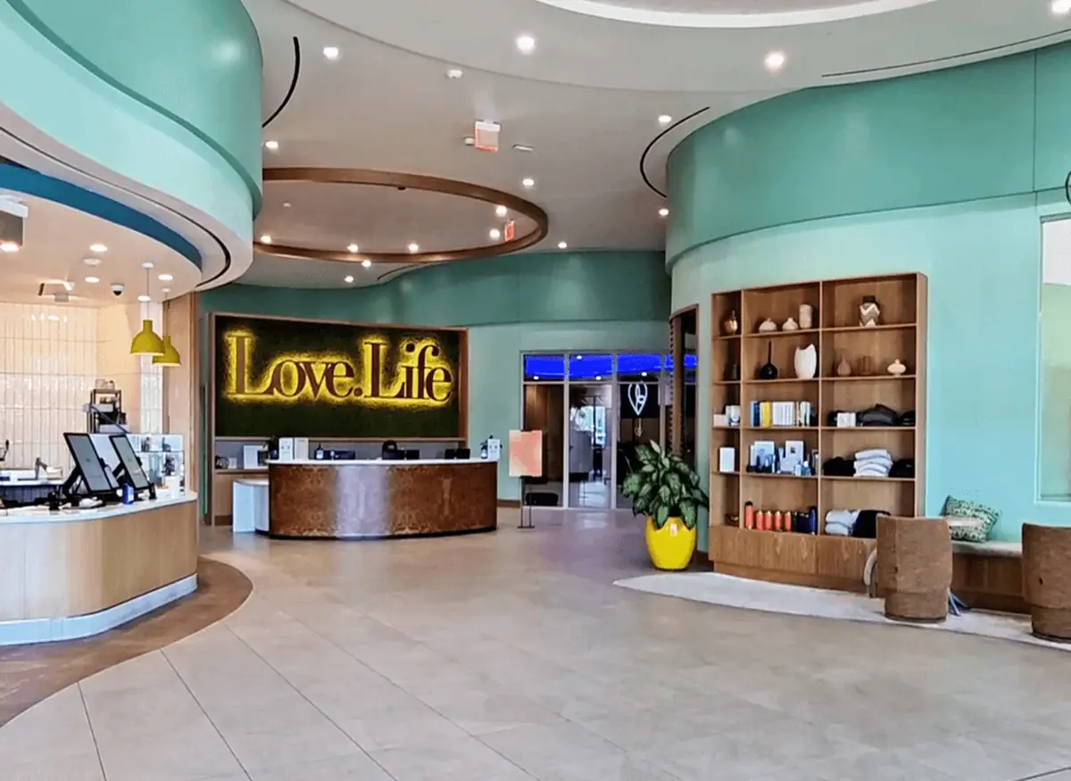 The front desk lobby of Love.Life wellness center, combining a doctor’s office, gym, and spa in a modern health club setting.