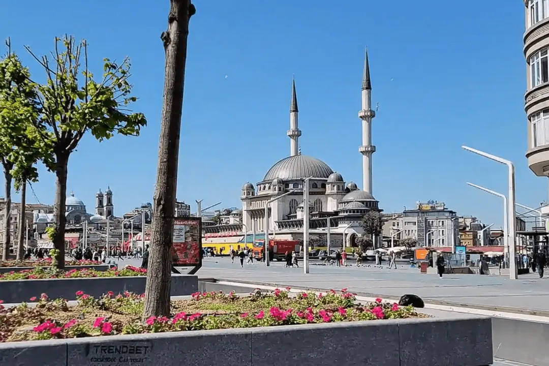 Taksim Square in Istanbul with the modern mosque and busy street scene, a central landmark near many hair transplant clinics.