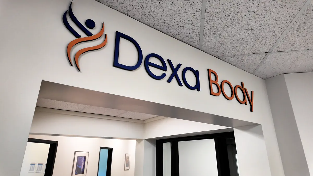 Interior photo of the DexaBody clinic entrance showing the Dexa Body logo above the doorway at their health testing facility.