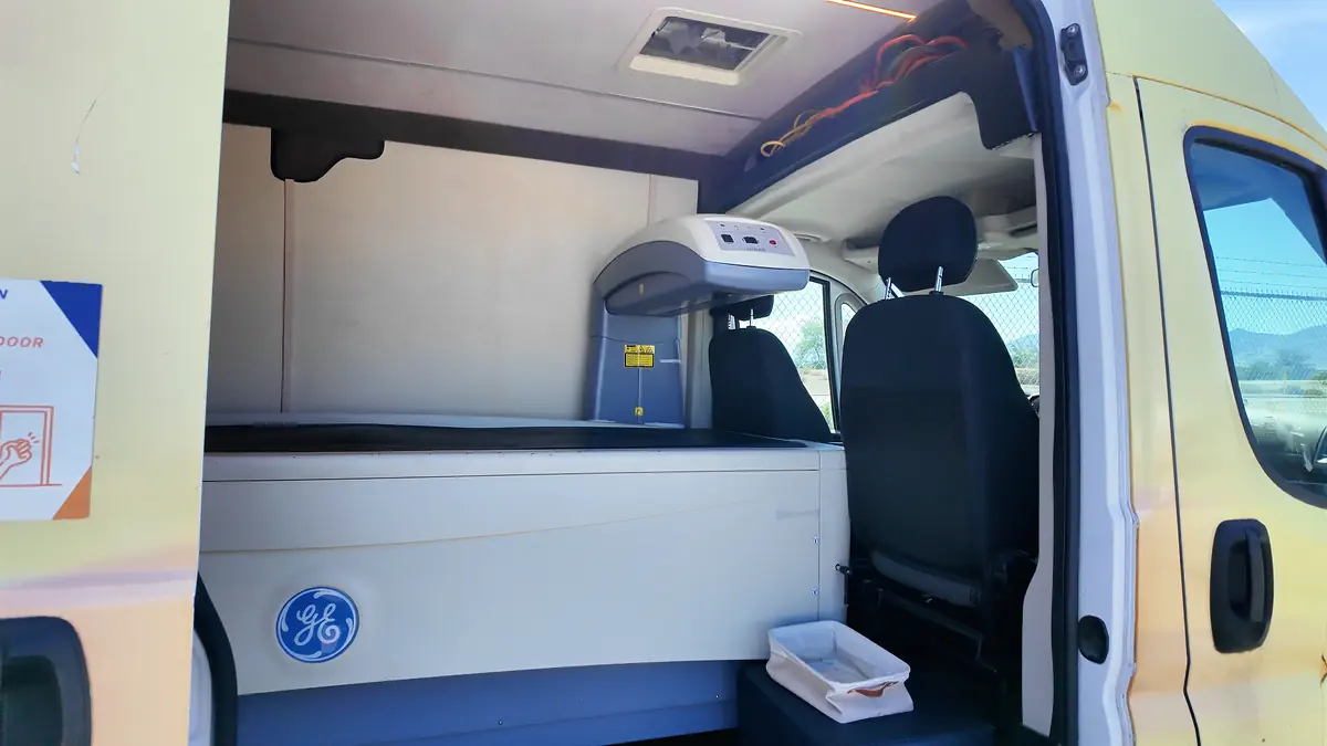 Interior of the DexaBody mobile testing van showing the GE Dexa scan machine used for body composition analysis and metabolic health testing.