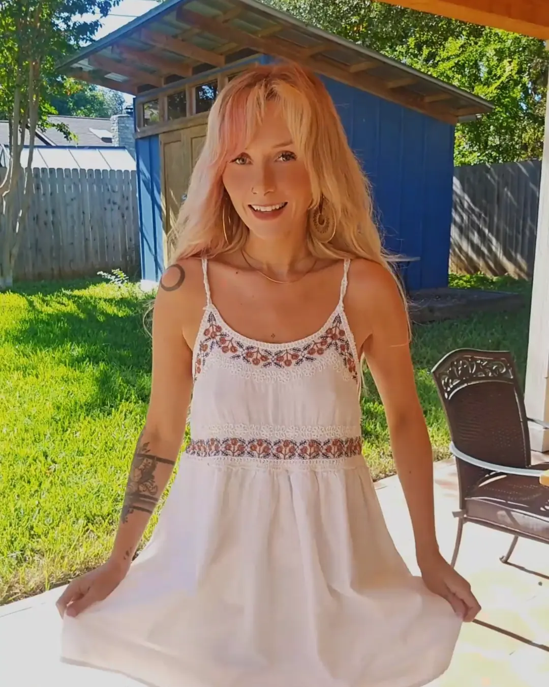 Woman wearing a white dress after alterations, showing the finished fit following tailoring in Medellín, Colombia