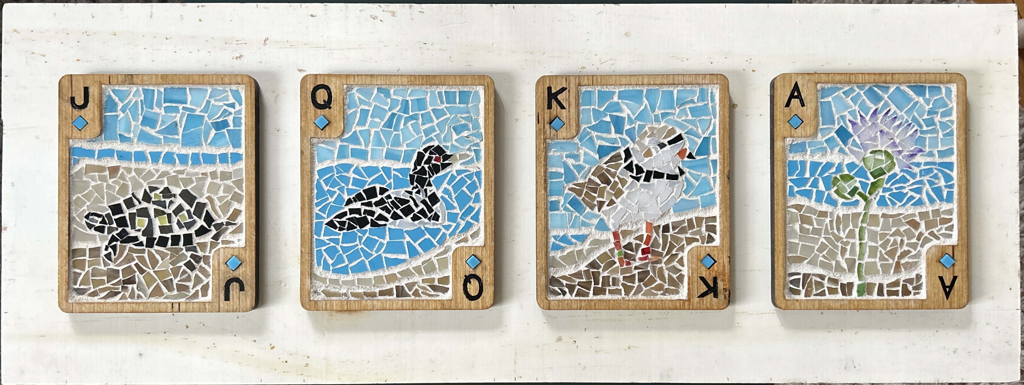 Playing cards made of wood and mosaic glass with Michigan native species