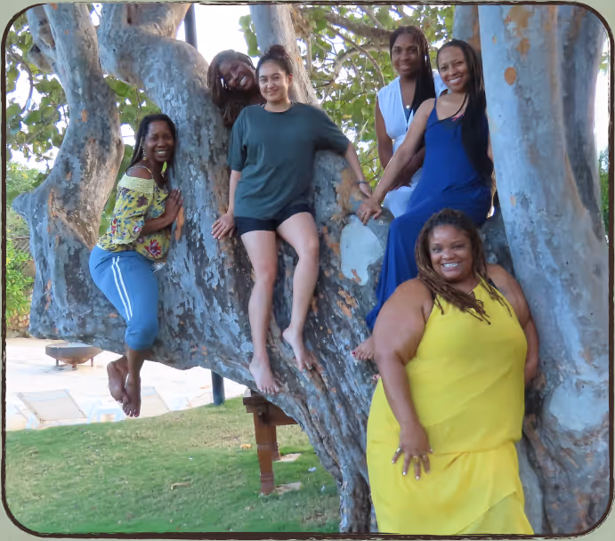 4DaSoil team posing in front of and on a tree.