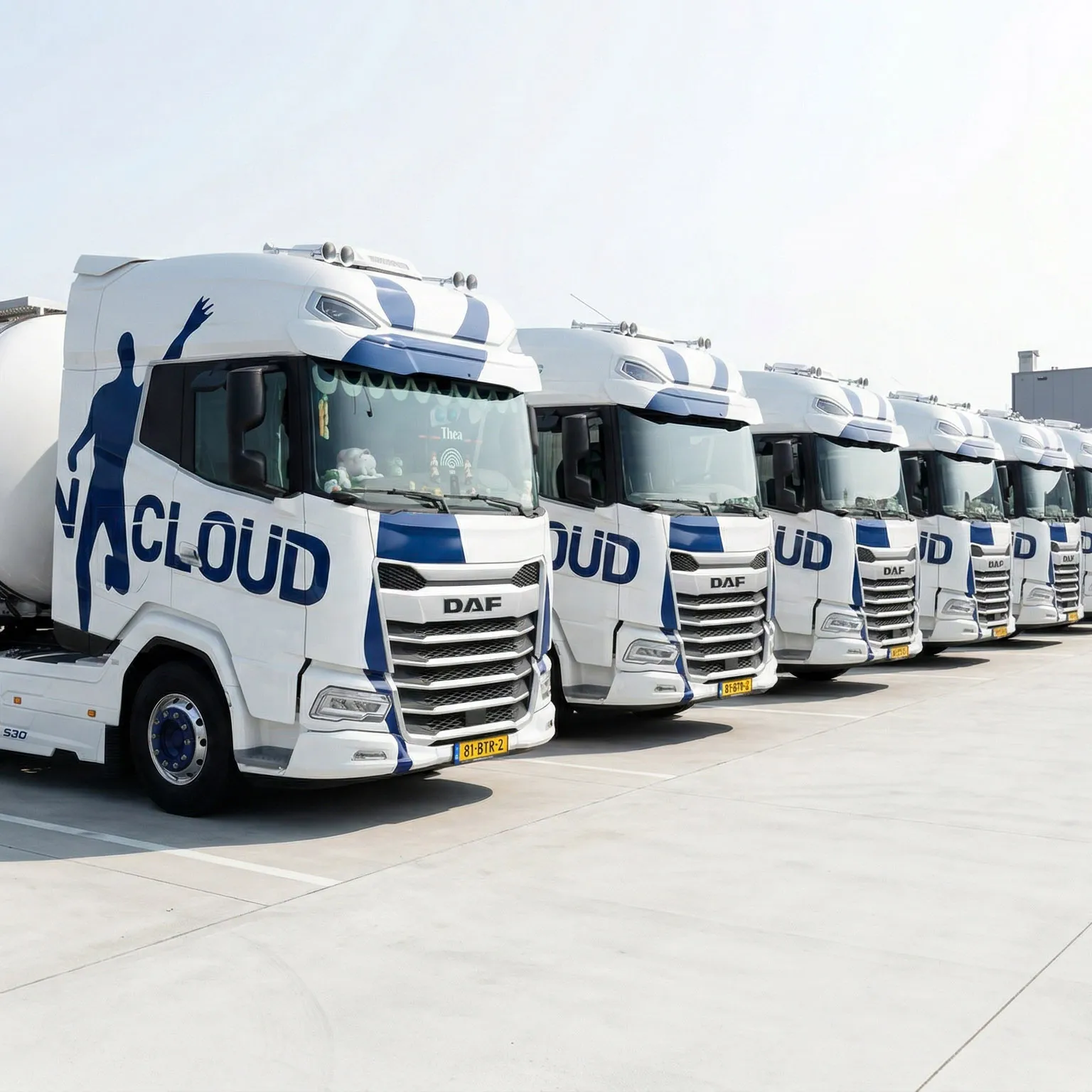 Row of white DAF trucks with blue graphics and the word 'CLOUD' on the doors, parked in a lot on a clear day.