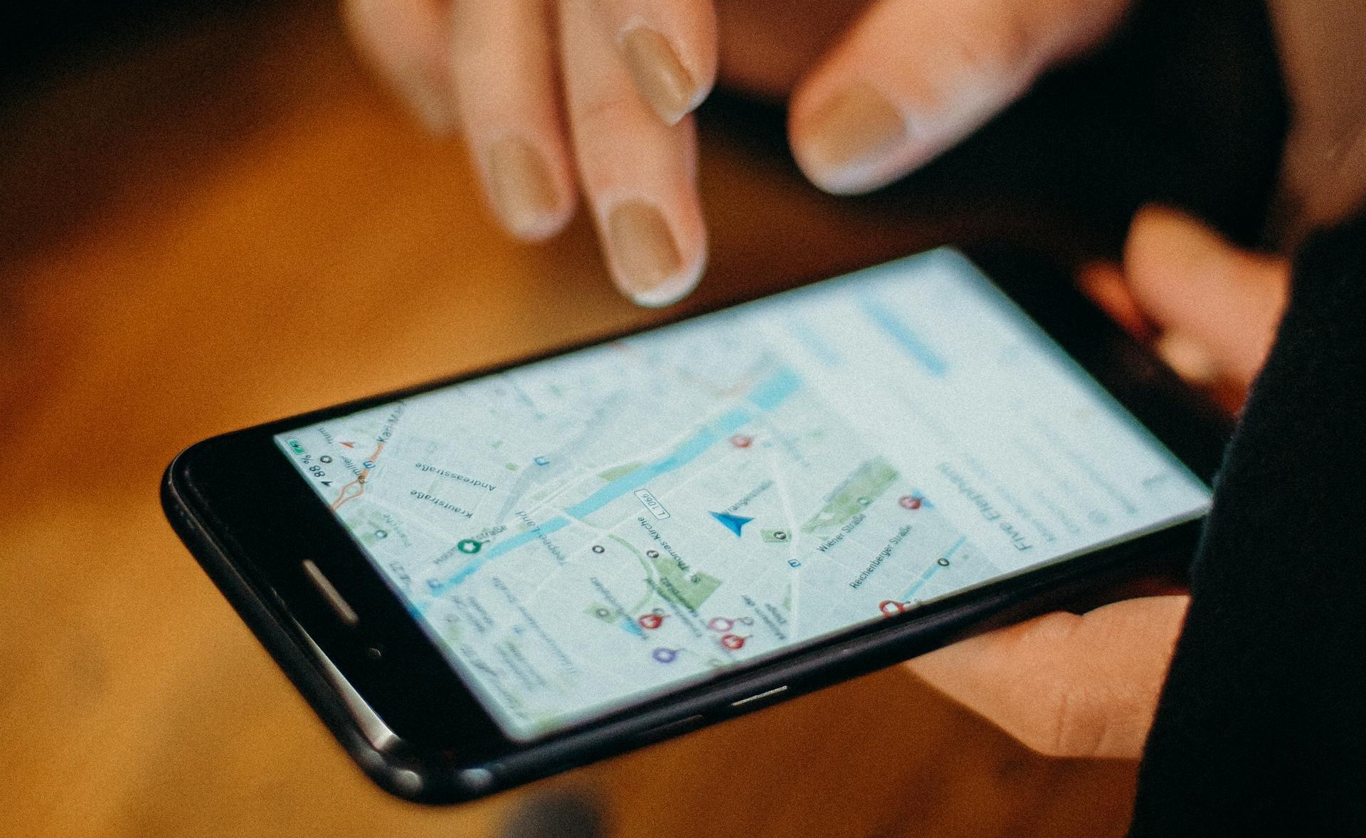 person using Google maps on black smartphone 