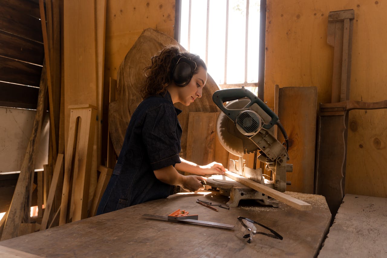 female carpenter working at saw