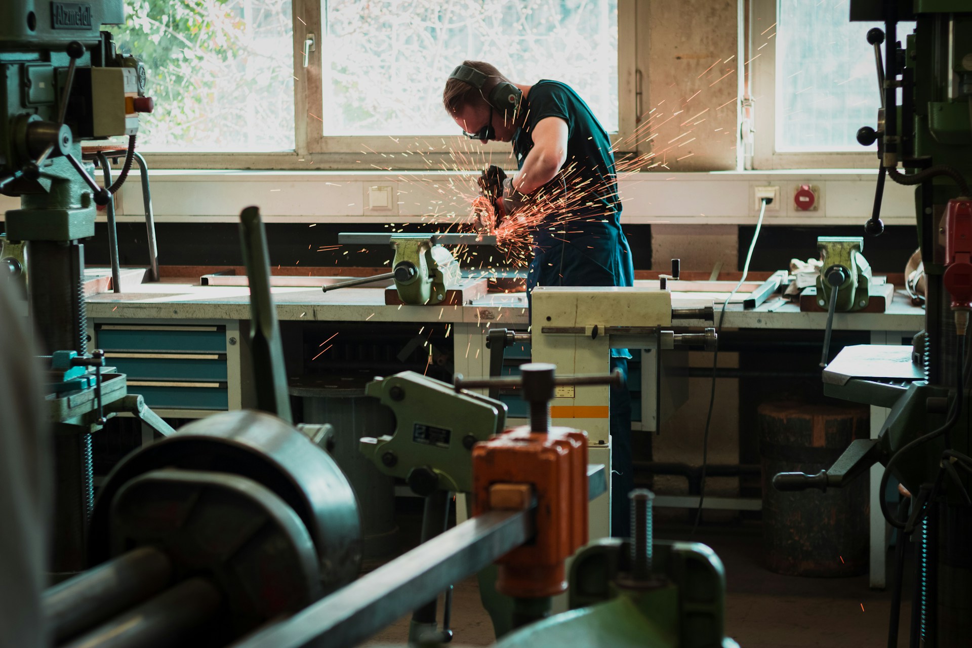 man working with grinder in workshop