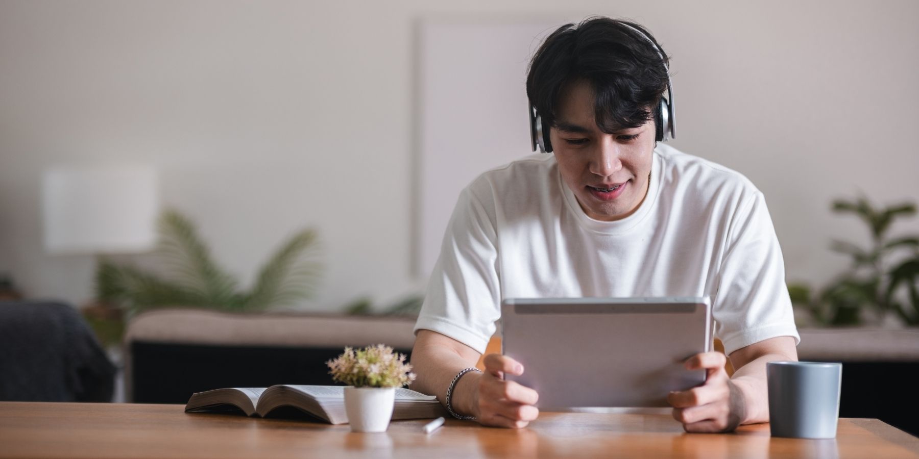 Man with headphones using AI marketing tablet in 2025, exploring smart skills for strategy